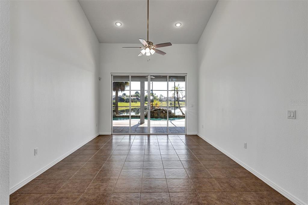 3728 Hunter's Isle Drive Orlando, FL 32837 - Photo 18 of 74 an empty room with floor to ceiling fan and windows
