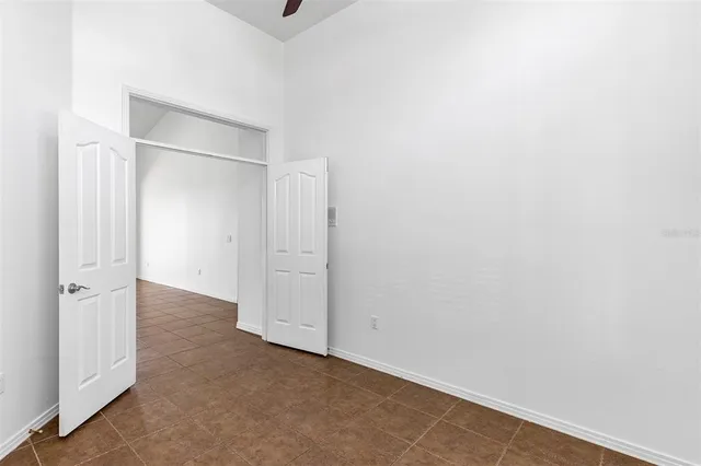 a view of an empty room with a fireplace and a window