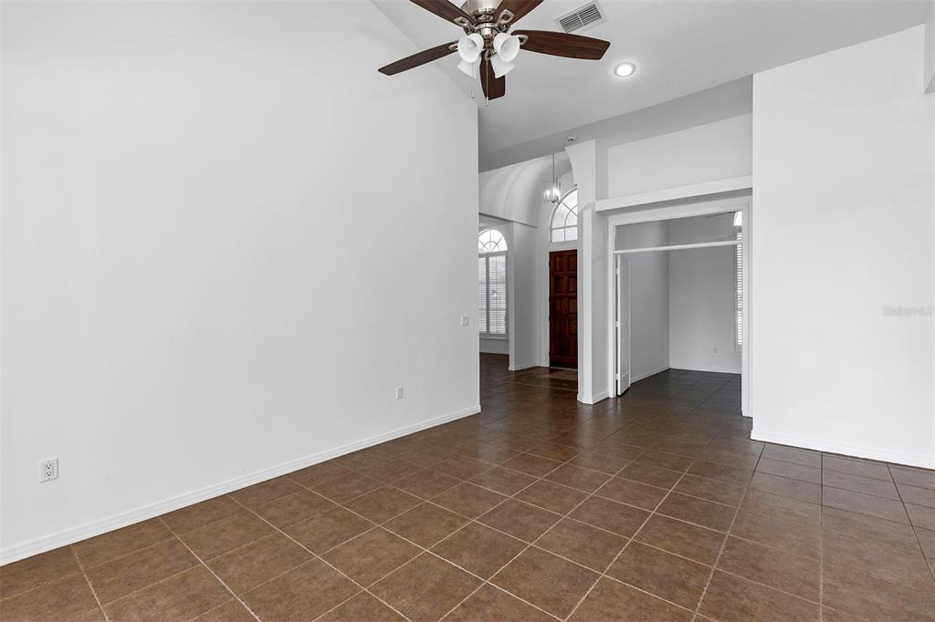 3728 Hunter's Isle Drive Orlando, FL 32837 - Photo 21 of 74 an empty room with a ceiling fan and carpet