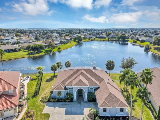 an aerial view of a house with a lake view