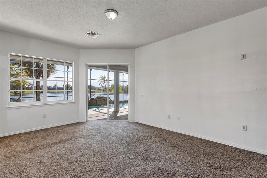 3728 Hunter's Isle Drive Orlando, FL 32837 - Photo 41 of 74 an empty room with floor to ceiling window and windows