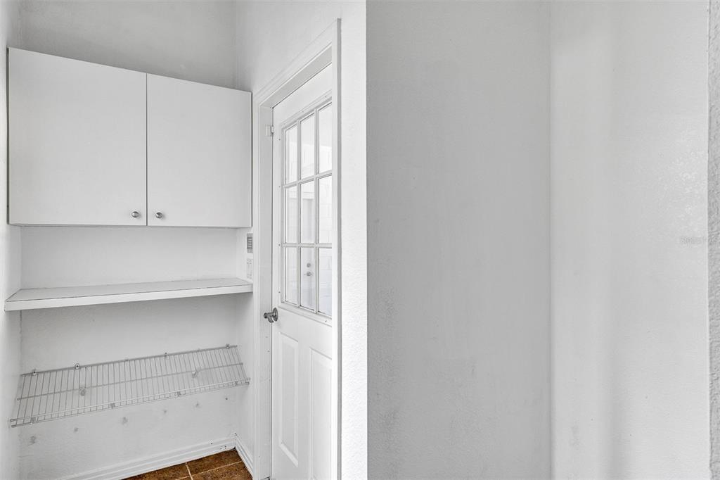 3728 Hunter's Isle Drive Orlando, FL 32837 - Photo 59 of 74 a view of cabinets and utility room with closet