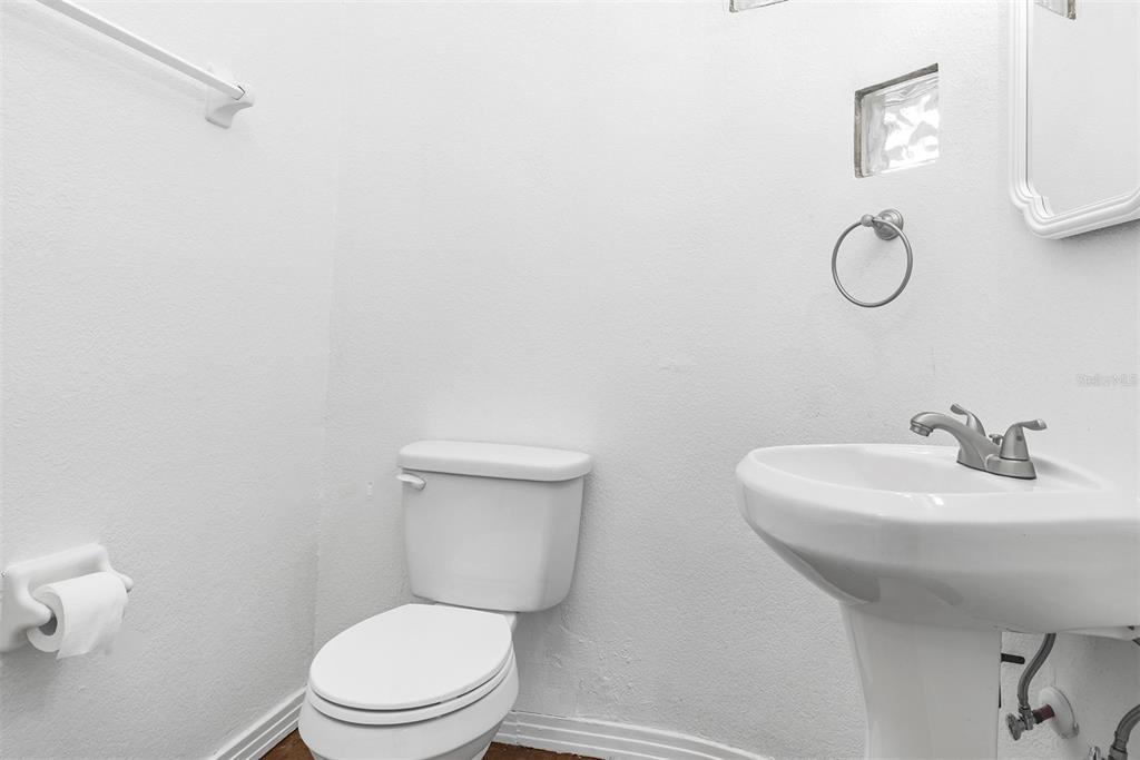 3728 Hunter's Isle Drive Orlando, FL 32837 - Photo 61 of 74 a bathroom with a toilet sink vanity and mirror