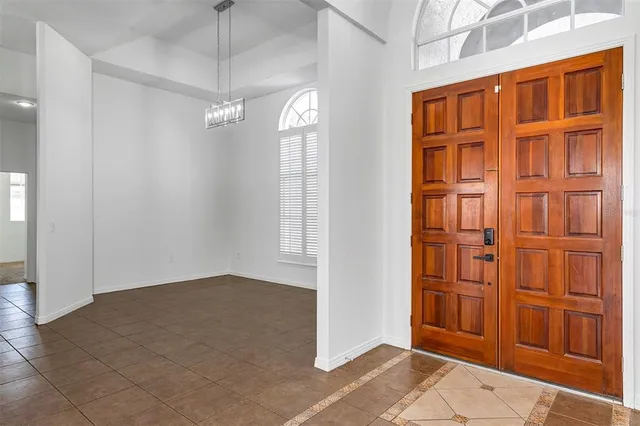 a view of a livingroom with wooden floor and a ceiling fan