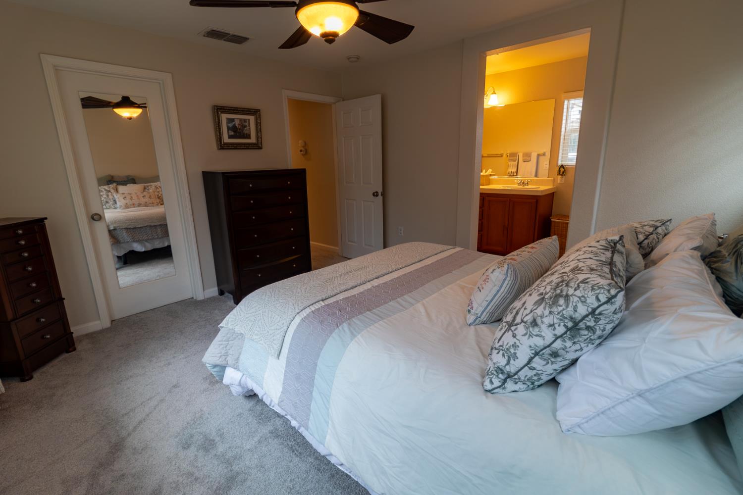 401 Picasso Way Folsom, CA 95630 - Photo 20 of 32 a bedroom with a bed and a chandelier