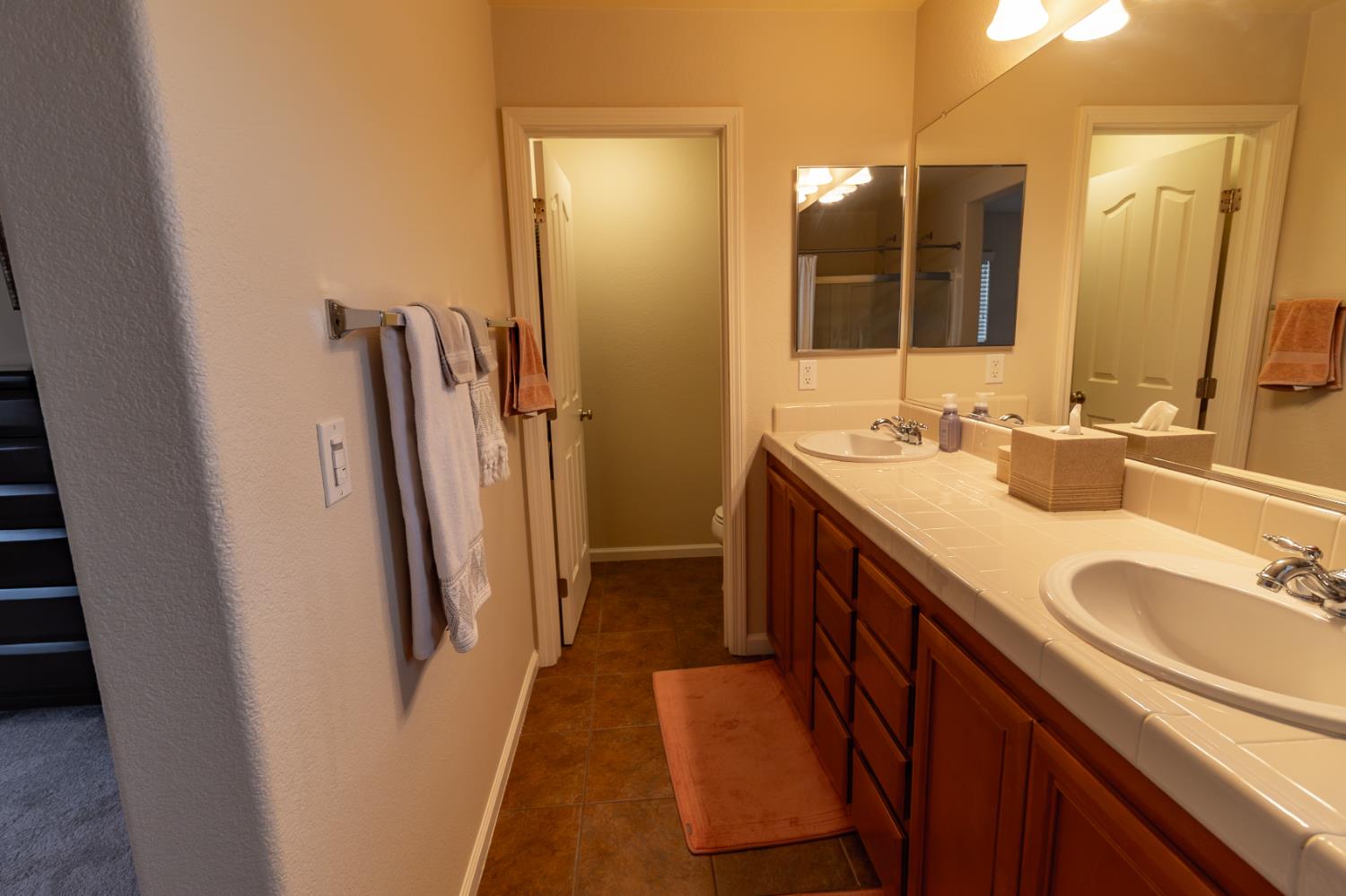 401 Picasso Way Folsom, CA 95630 - Photo 22 of 32 a bathroom with double vanity and a mirror
