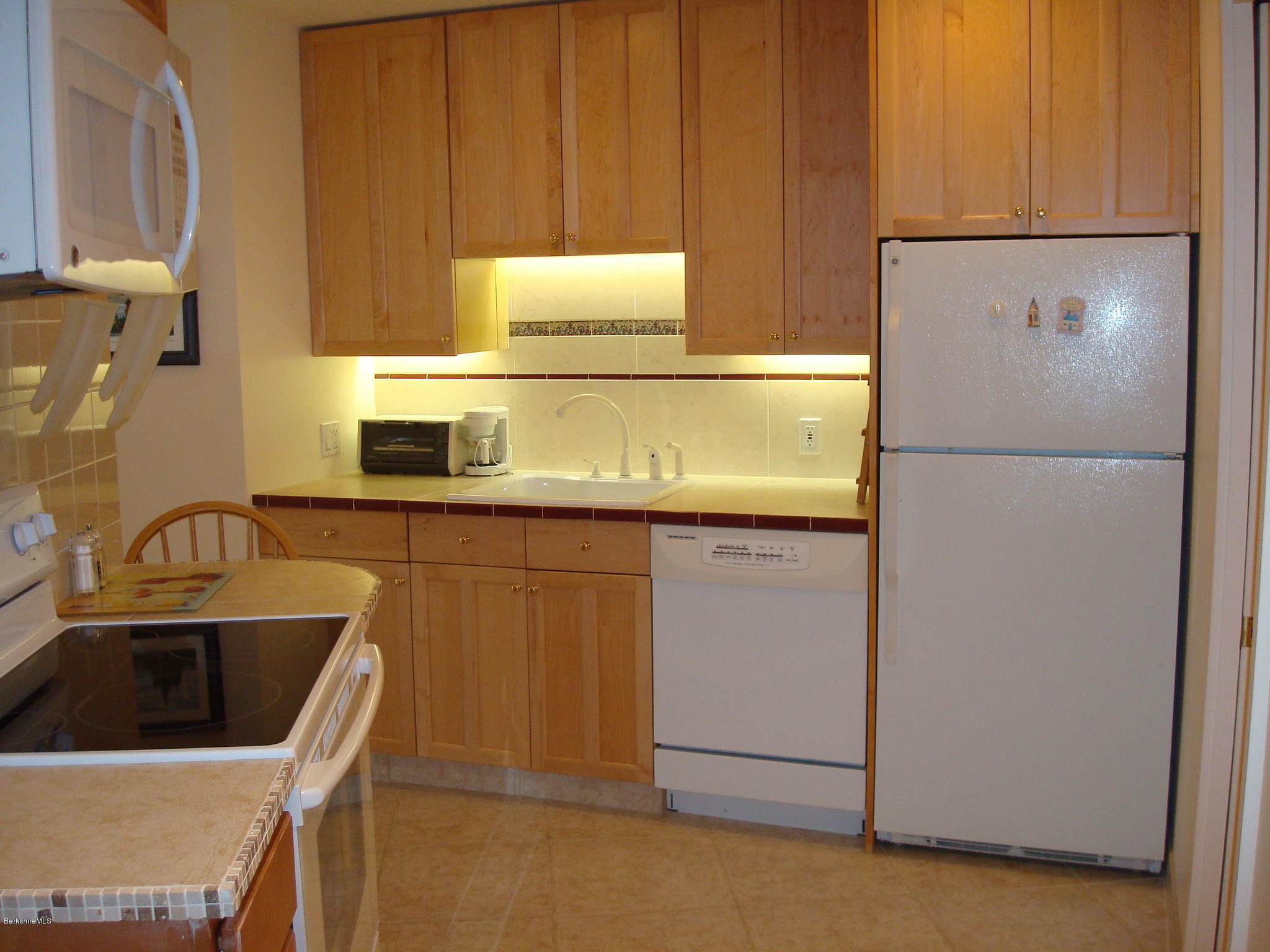 1151 E Road Richmond, MA 01254 - Photo 33 of 33 a kitchen with stainless steel appliances granite countertop white refrigerator sink and cabinets