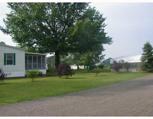88 Mitchell Road West Middlesex, PA 16159 - Photo 2 of 15 Exterior Back. Lovely screened porch , shade tree and carport. Shed in background stays.