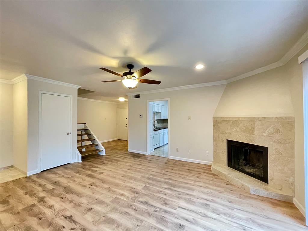 336 Melrose Drive, Unit 5C Richardson, TX 75080 - Photo 6 of 22 a view of empty room with wooden floor and fireplace