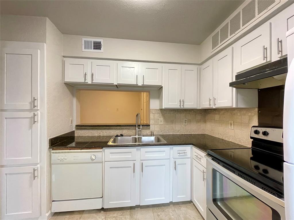 336 Melrose Drive, Unit 5C Richardson, TX 75080 - Photo 10 of 22 a kitchen with granite countertop a sink stove and cabinets
