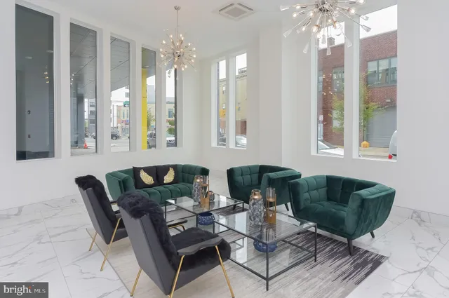 a living room with furniture and a chandelier