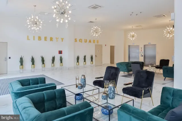 a living room with furniture and a chandelier