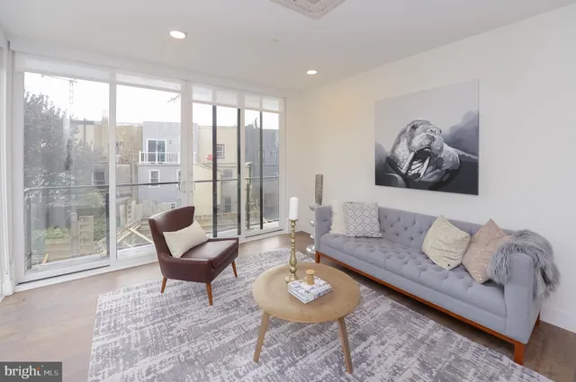 a living room with furniture and a large window