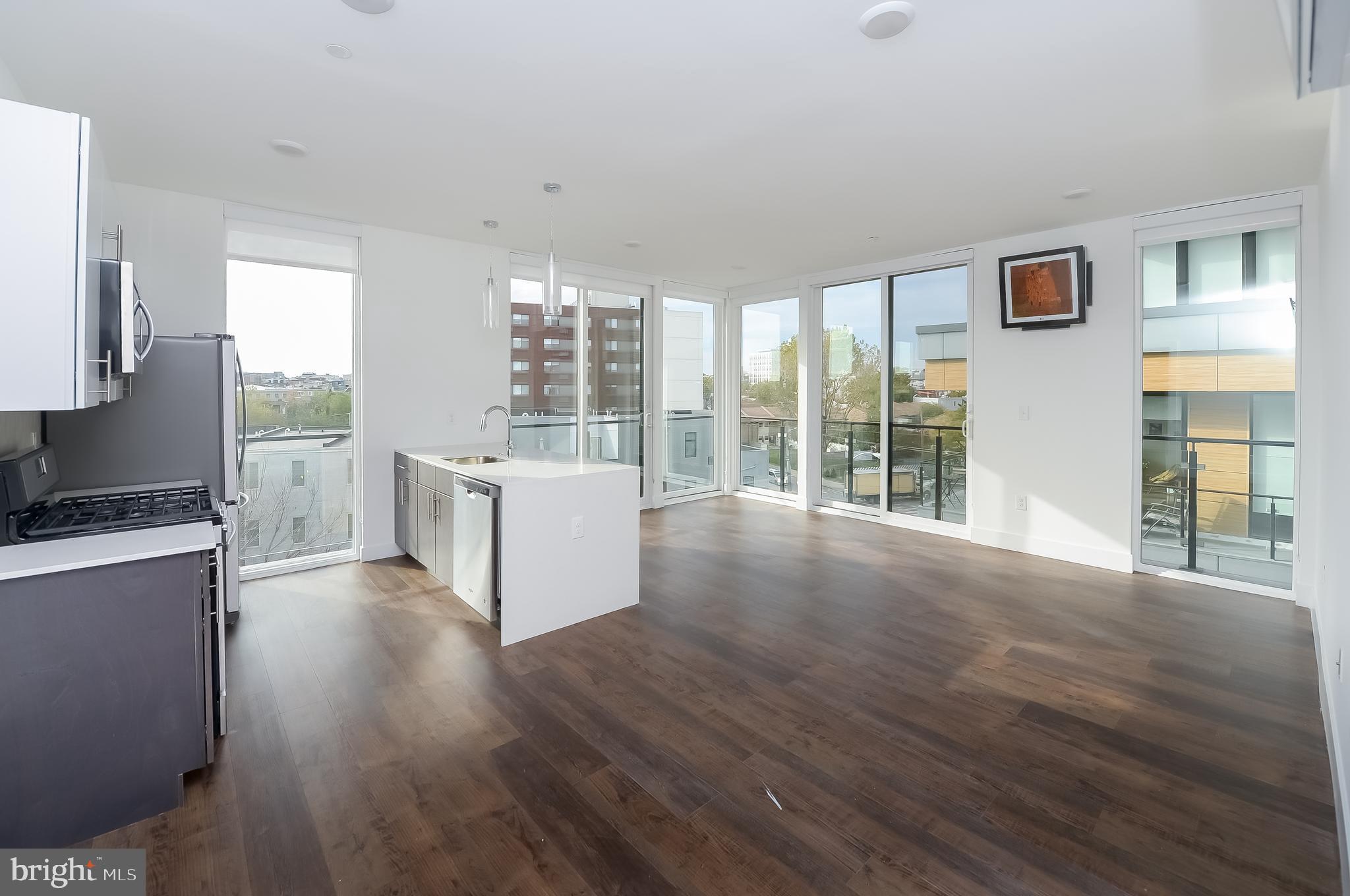 236 West Thompson Street, Unit B401 Philadelphia, PA 19122 - Photo 31 of 48 a view of a kitchen with wooden floor and a window