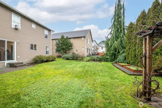 a view of backyard of house with green space