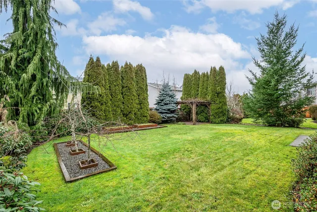 a view of a yard with a house in the background