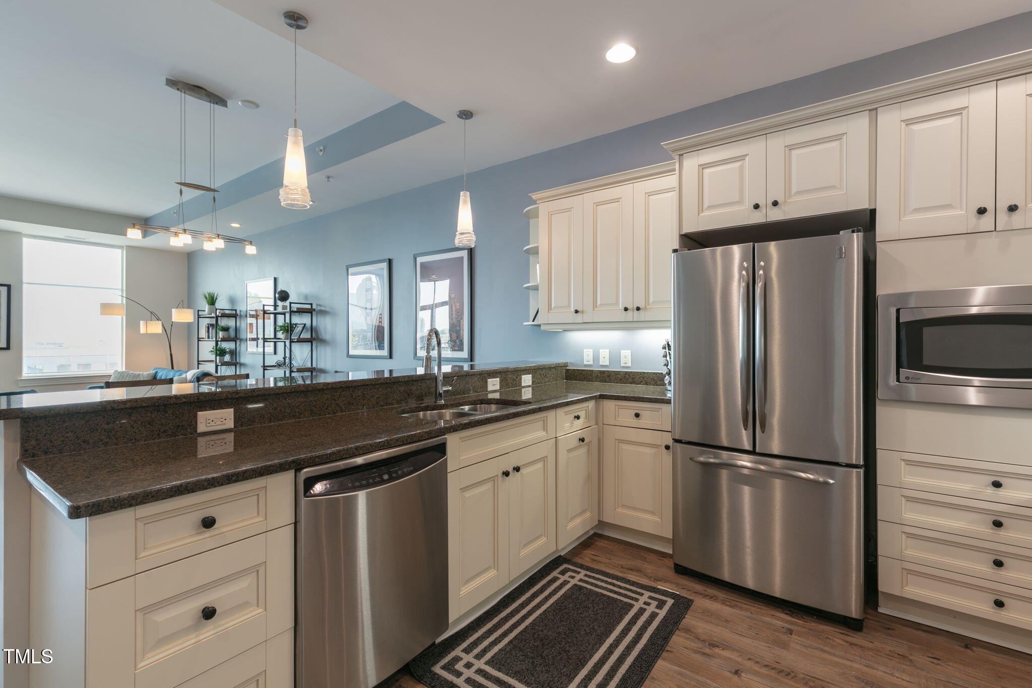 400 West North Street, Unit 1134 Raleigh, NC 27603 - Photo 10 of 39 a kitchen with granite countertop a refrigerator stove and cabinets