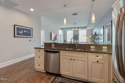 a kitchen with stainless steel appliances a stove a refrigerator and cabinets