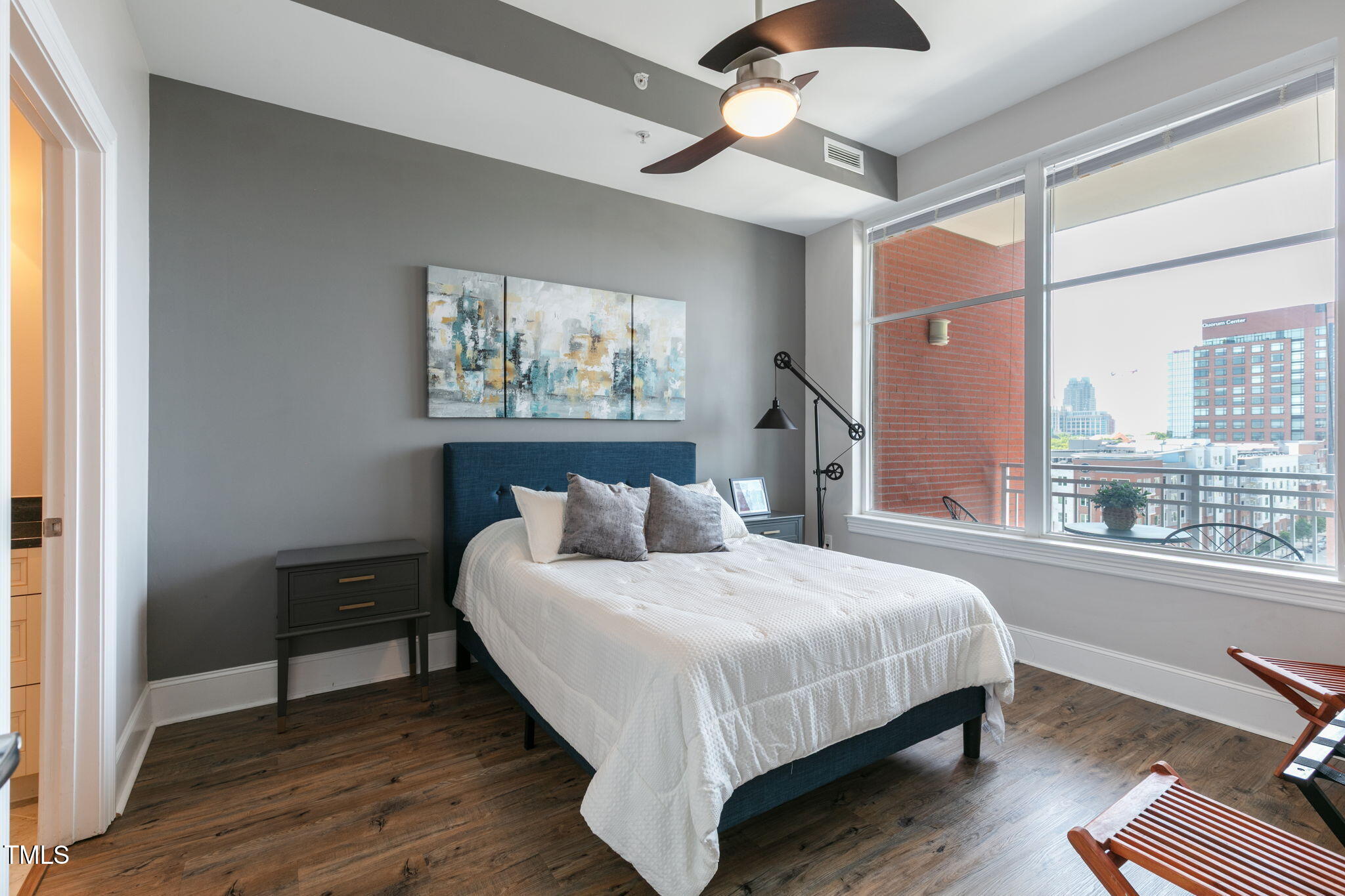 400 West North Street, Unit 1134 Raleigh, NC 27603 - Photo 13 of 39 a bedroom with a bed chandelier and a window