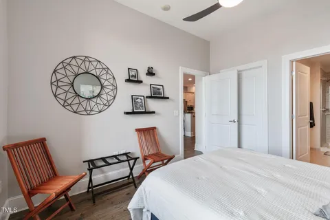a bedroom with a bed and a large window