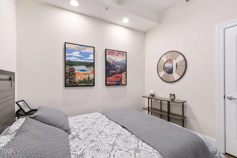 a bedroom with a bed and wooden floor