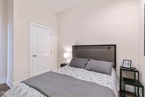 a bedroom with a bed and a chandelier