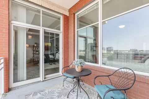 a view of a balcony with chair and potted plant