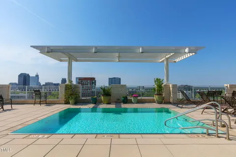 a view of a swimming pool with outdoor seating