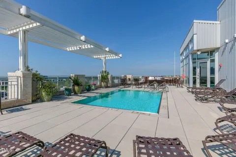 a room with pool table and chairs