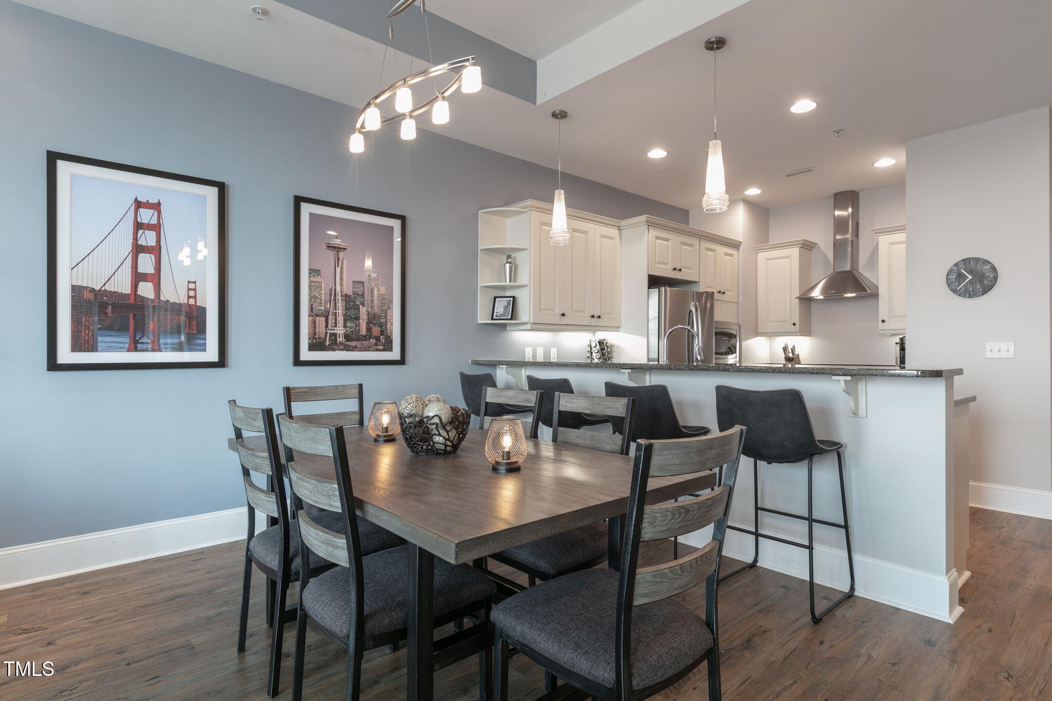 400 West North Street, Unit 1134 Raleigh, NC 27603 - Photo 7 of 39 a dining room with stainless steel appliances kitchen island granite countertop a dining table chairs and a refrigerator