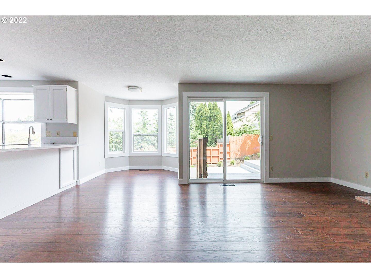 7354 Southwest 166th Terrace Beaverton, OR 97007 - Photo 11 of 32 a view of an empty room with wooden floor and a window
