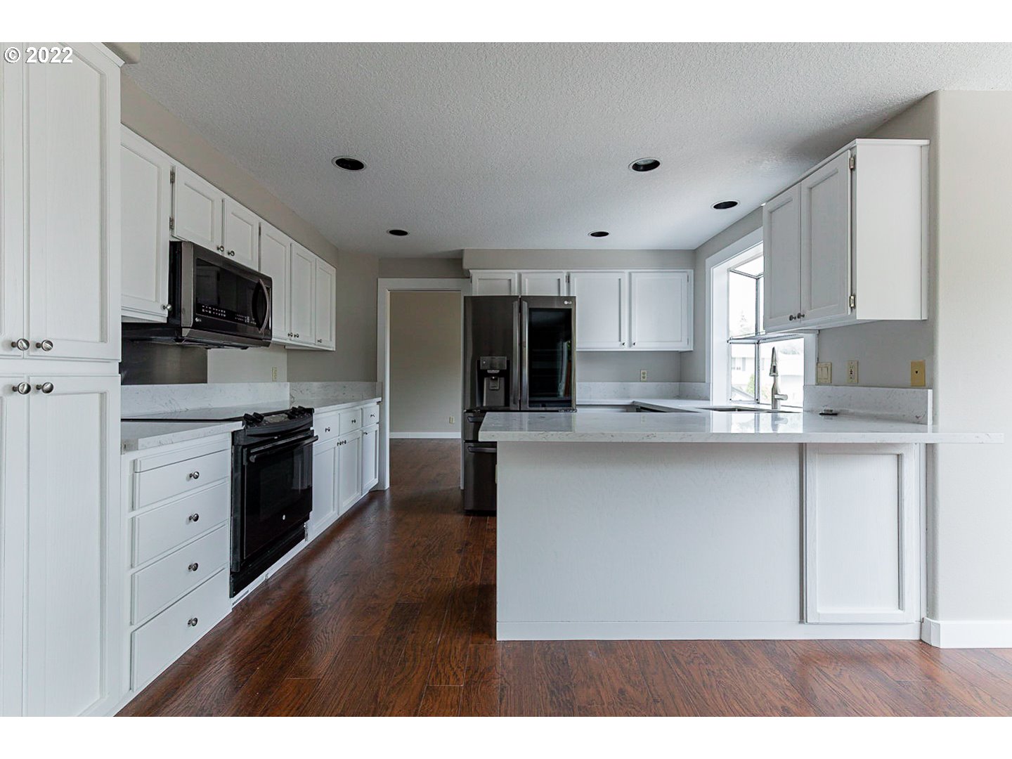 7354 Southwest 166th Terrace Beaverton, OR 97007 - Photo 2 of 32 a kitchen with white cabinets sink and stainless steel appliances