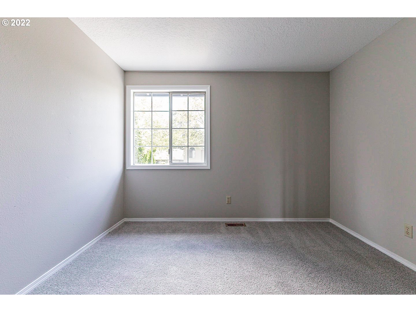 7354 Southwest 166th Terrace Beaverton, OR 97007 - Photo 21 of 32 an empty room with wooden floor and windows