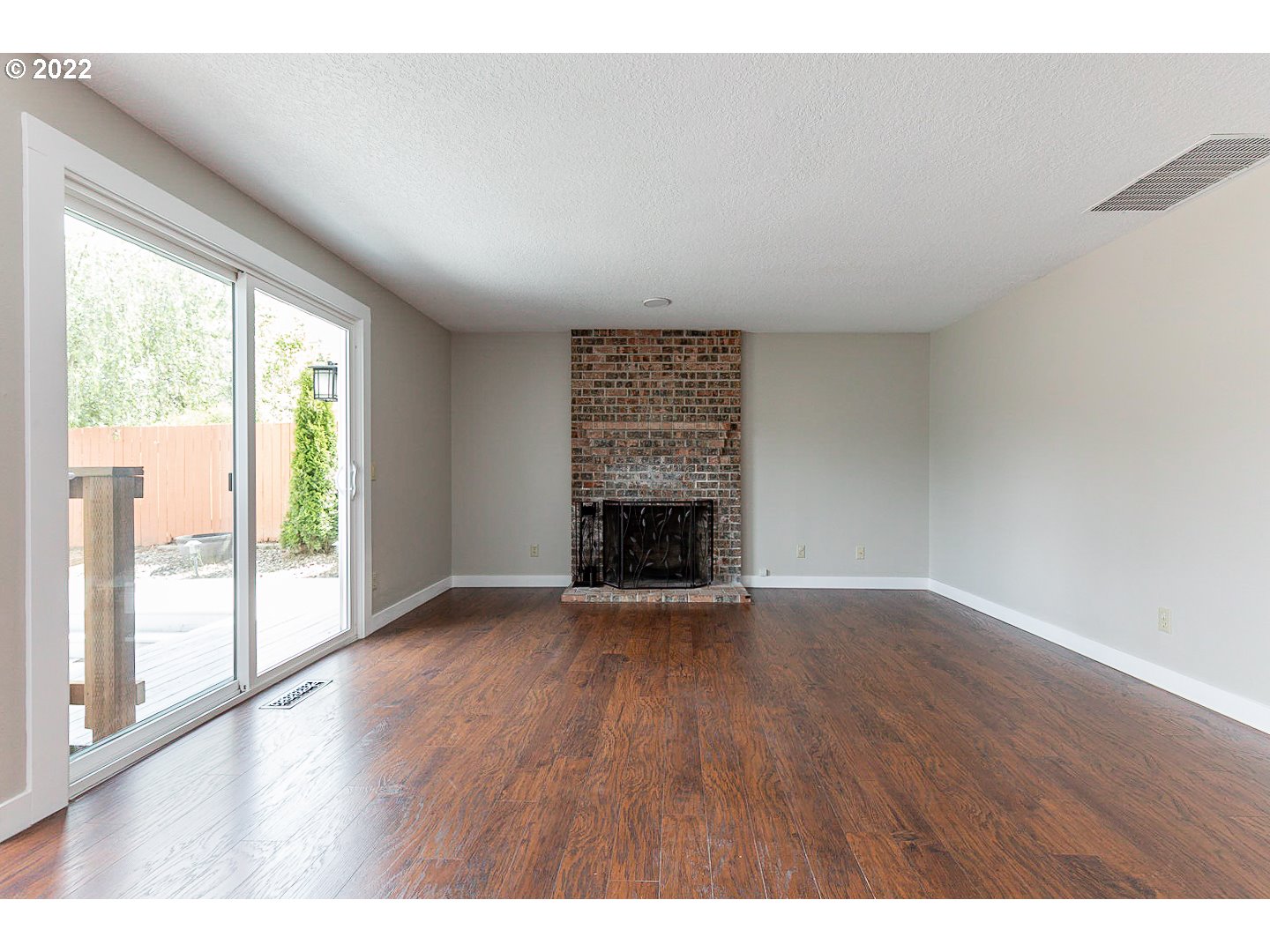 7354 Southwest 166th Terrace Beaverton, OR 97007 - Photo 3 of 32 a view of an empty room with wooden floor and a window