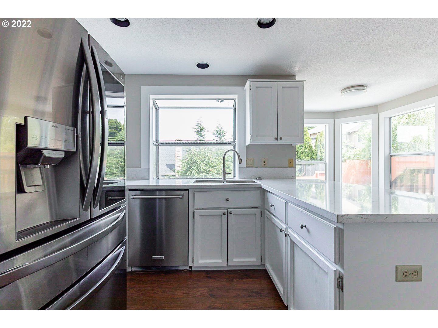 7354 Southwest 166th Terrace Beaverton, OR 97007 - Photo 6 of 32 a kitchen with granite countertop a stove a sink and a refrigerator