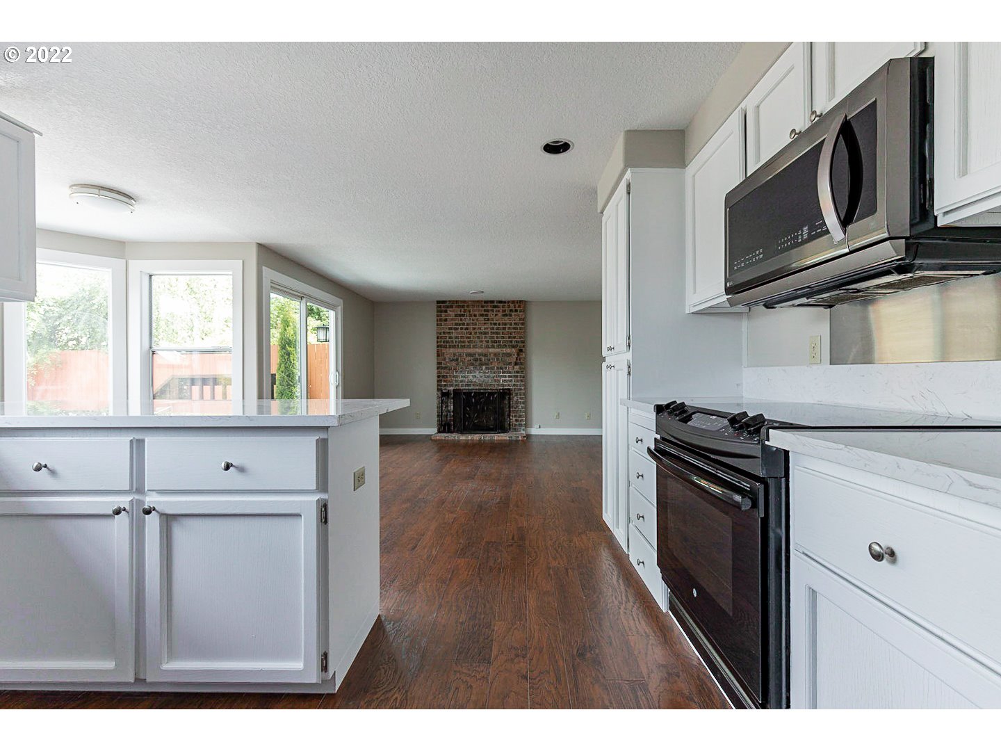 7354 Southwest 166th Terrace Beaverton, OR 97007 - Photo 7 of 32 a kitchen with stainless steel appliances granite countertop a stove a microwave and a refrigerator