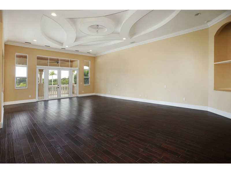 13607 Bella Ranch Lane Southwest Ranches, FL 33330 - Photo 11 of 19 a view of an empty room with wooden floor and a window