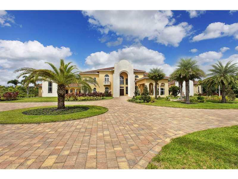13607 Bella Ranch Lane Southwest Ranches, FL 33330 - Photo 5 of 19 a front view of a house with a yard