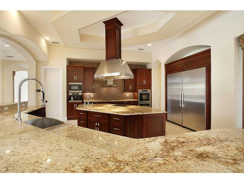 13607 Bella Ranch Lane Southwest Ranches, FL 33330 - Photo 10 of 19 a large kitchen with stainless steel appliances kitchen island granite countertop a stove and a refrigerator