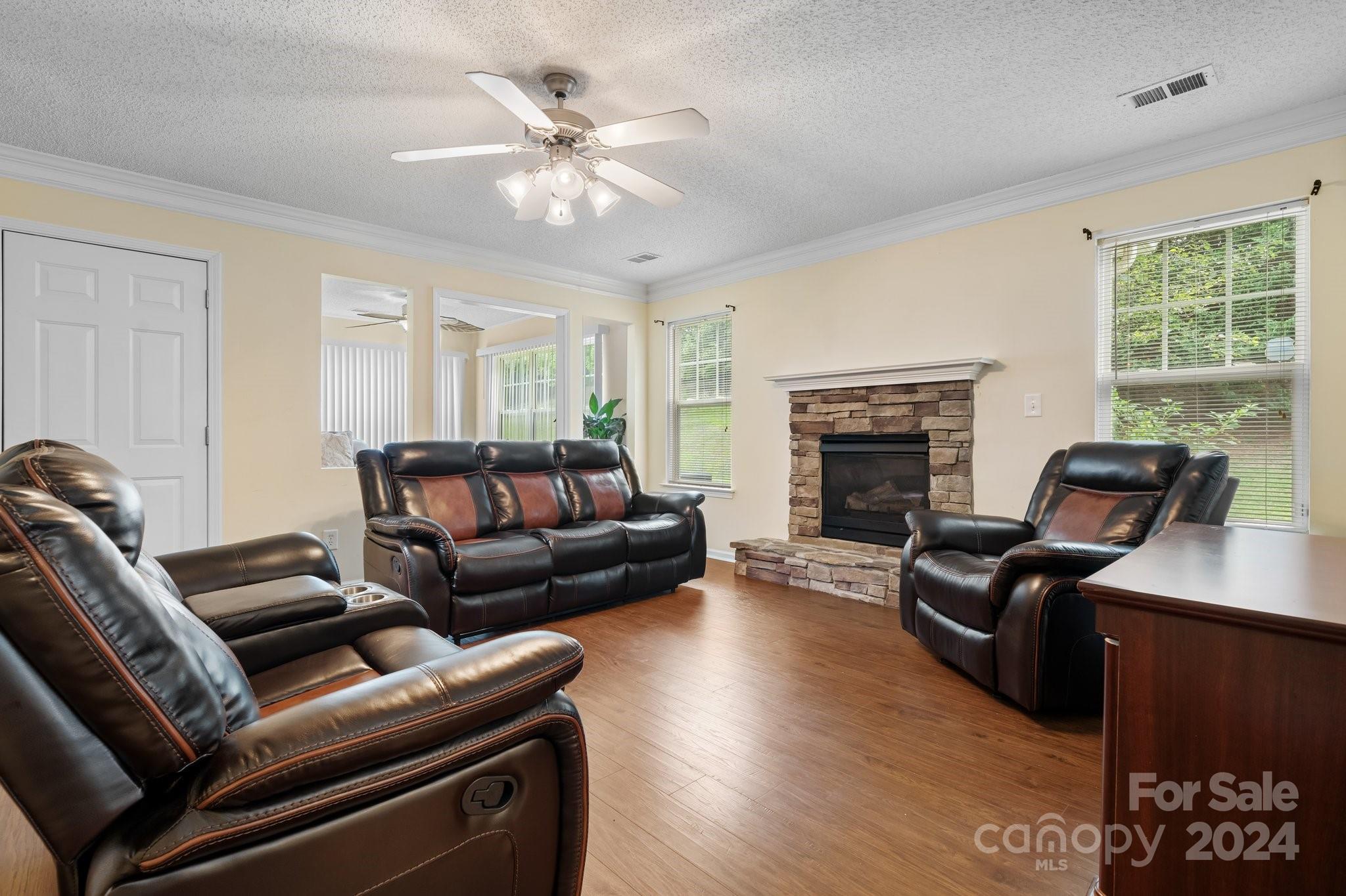 813 Raindrops Road Gastonia, NC 28054 - Photo 13 of 42 a living room with furniture a fireplace and a flat screen tv