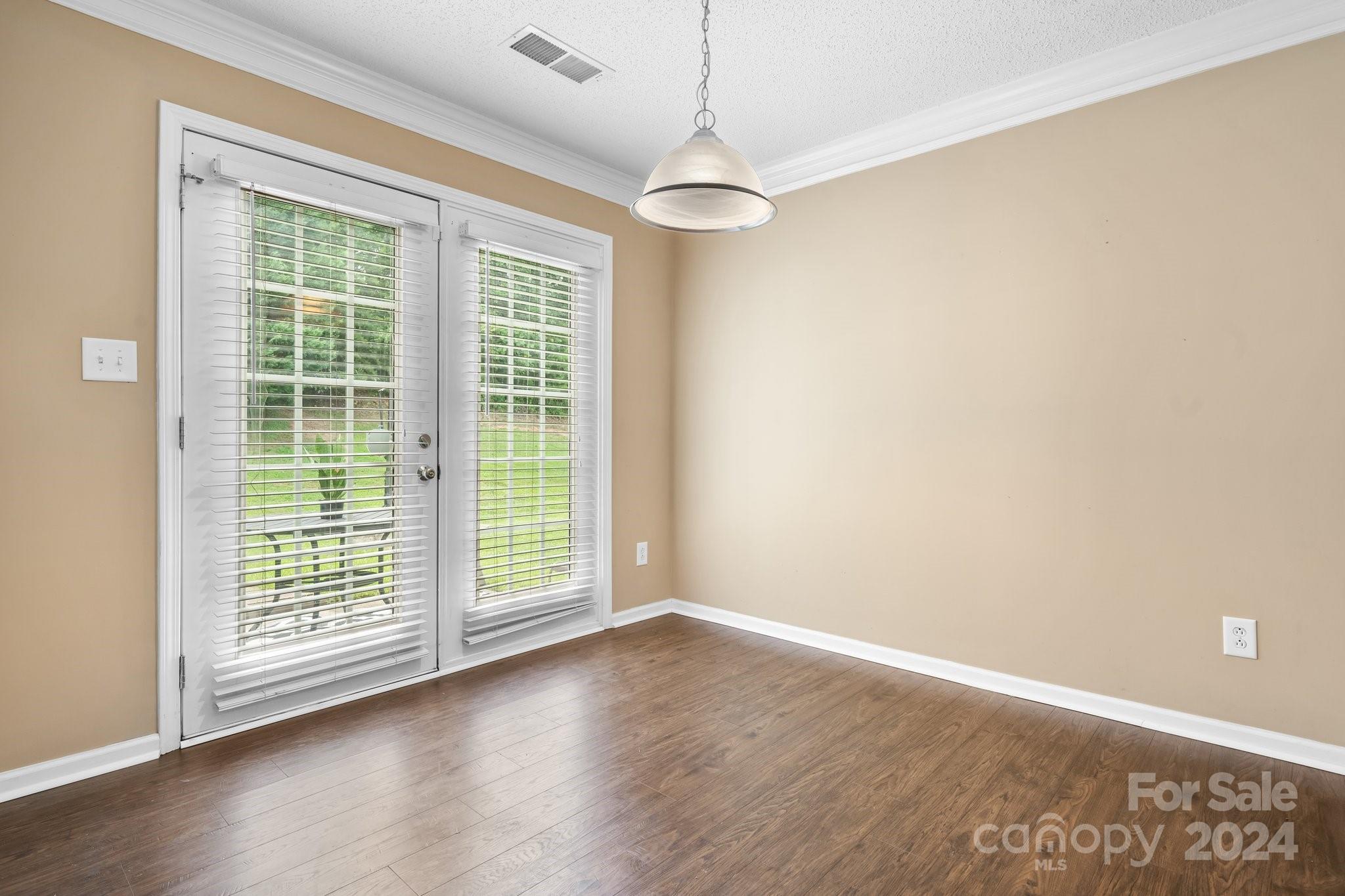 813 Raindrops Road Gastonia, NC 28054 - Photo 16 of 42 a view of an empty room with wooden floor and a window