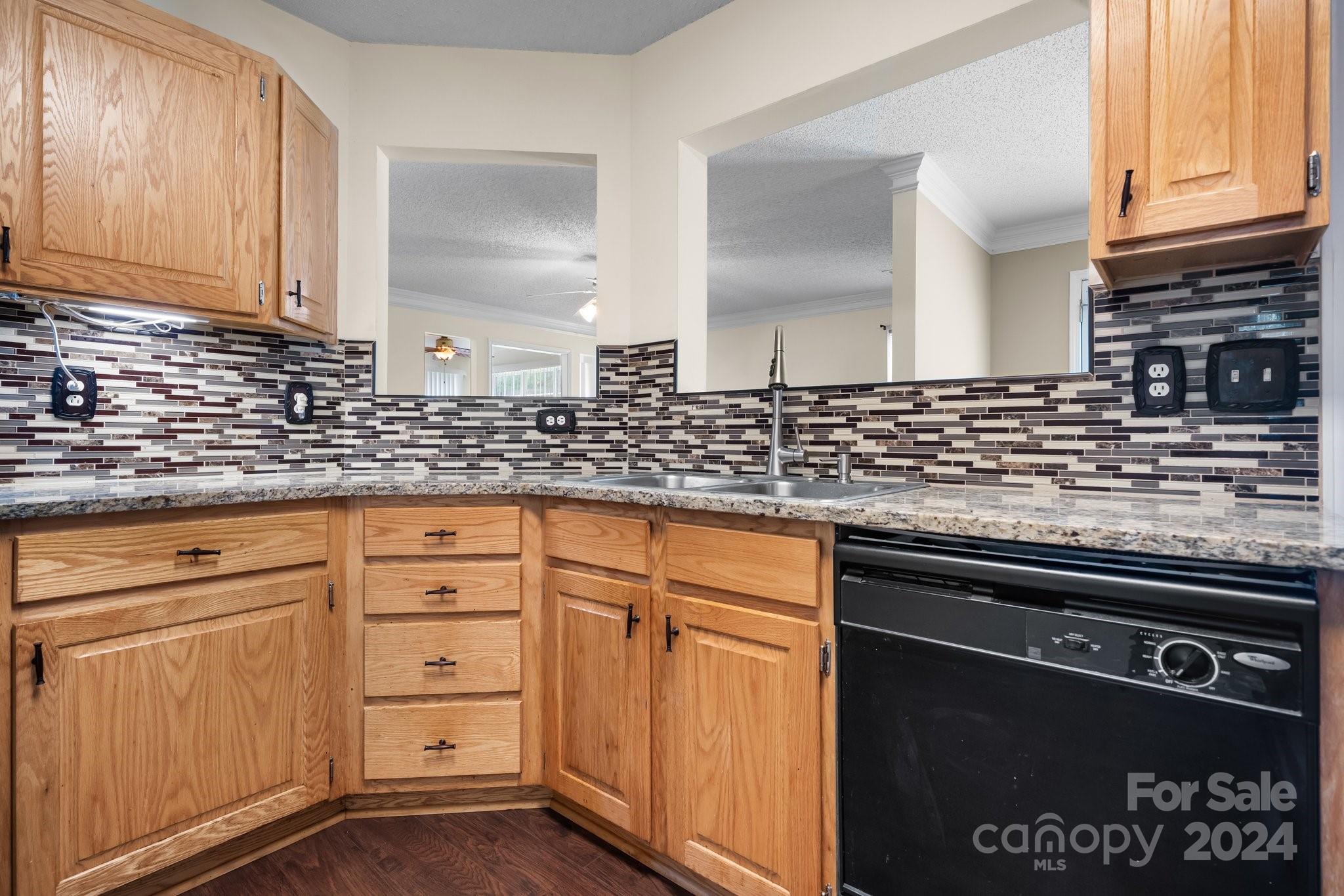 813 Raindrops Road Gastonia, NC 28054 - Photo 19 of 42 a kitchen with granite countertop a sink and cabinets
