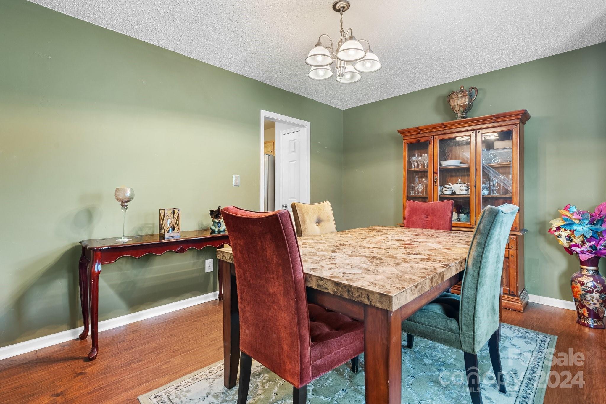 813 Raindrops Road Gastonia, NC 28054 - Photo 21 of 42 a view of a dining room with furniture and wooden floor