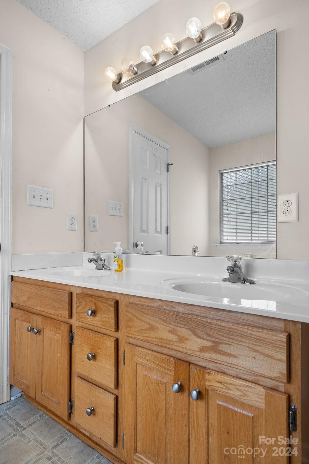 813 Raindrops Road Gastonia, NC 28054 - Photo 30 of 42 a bathroom with a sink double vanity and a mirror