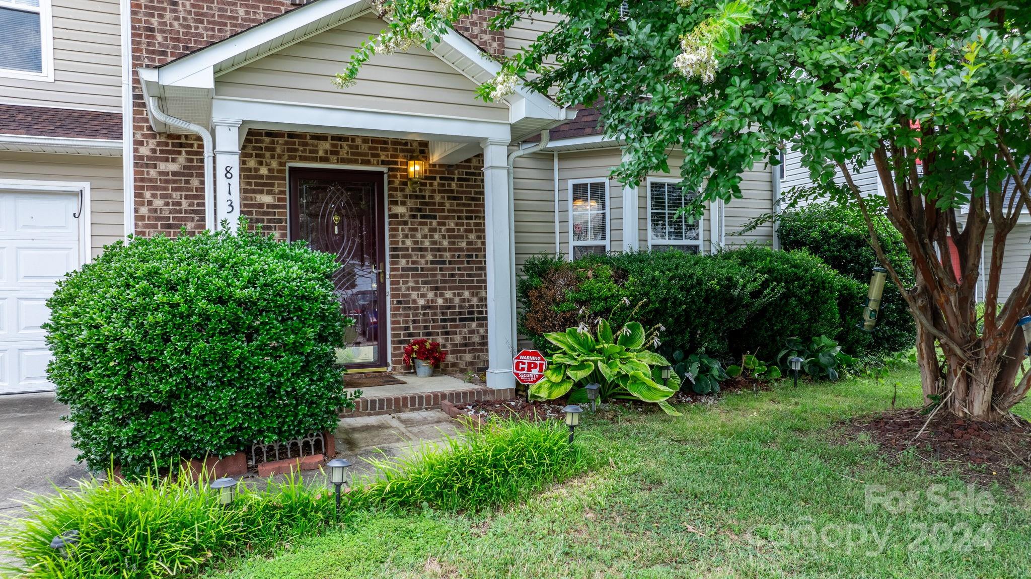 813 Raindrops Road Gastonia, NC 28054 - Photo 3 of 42 a view of brick house with a yard and plants