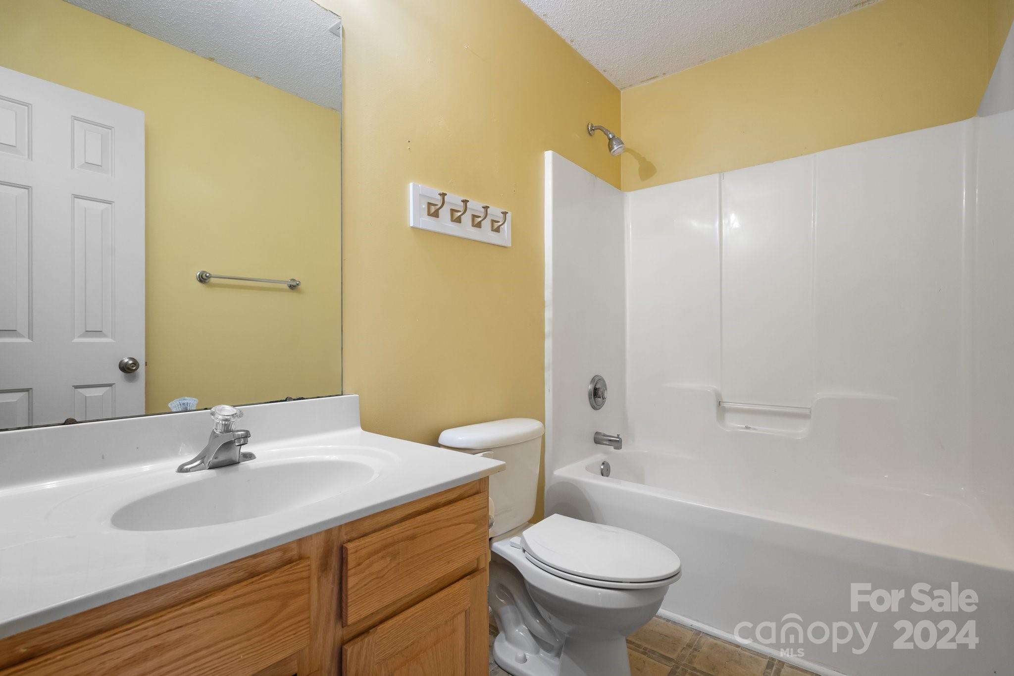 813 Raindrops Road Gastonia, NC 28054 - Photo 33 of 42 a bathroom with a sink a toilet and shower