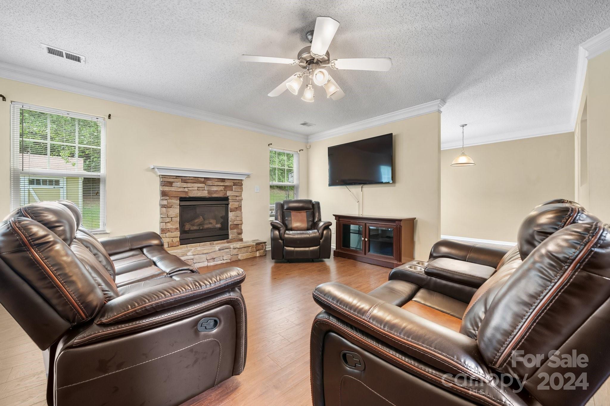 813 Raindrops Road Gastonia, NC 28054 - Photo 10 of 42 a living room with furniture a fireplace and a flat screen tv