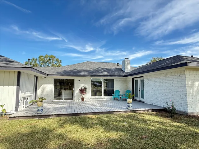 a view of a house with pool and chairs