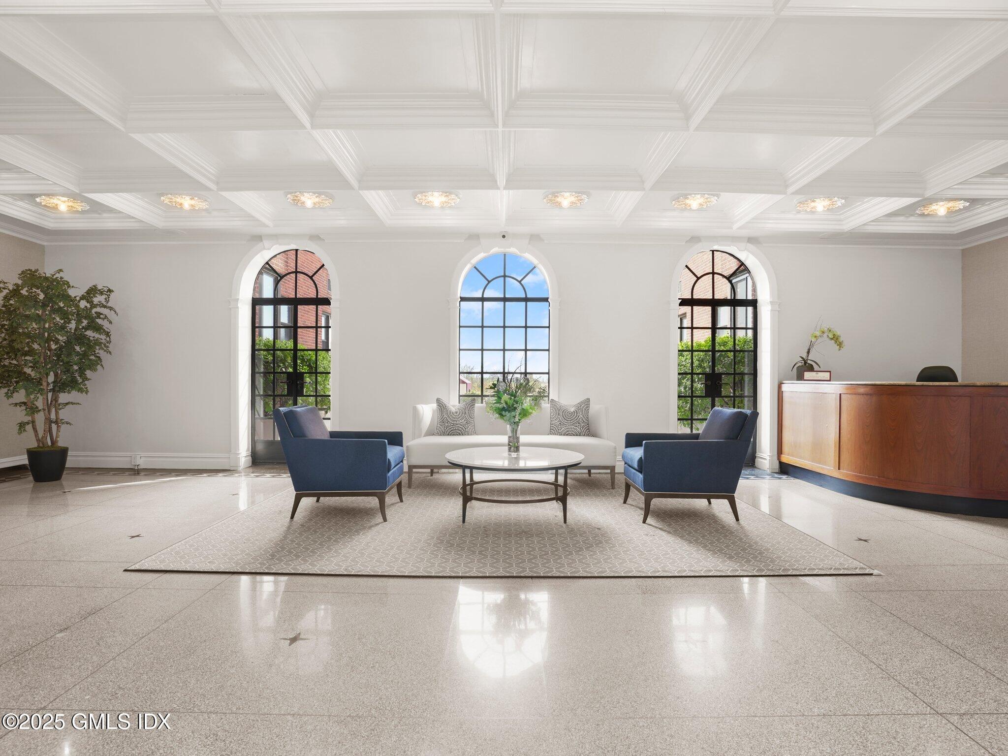 40 West Elm Street, Unit 1M Greenwich, CT 06830 - Photo 13 of 16 a living room with furniture chandelier and a large window