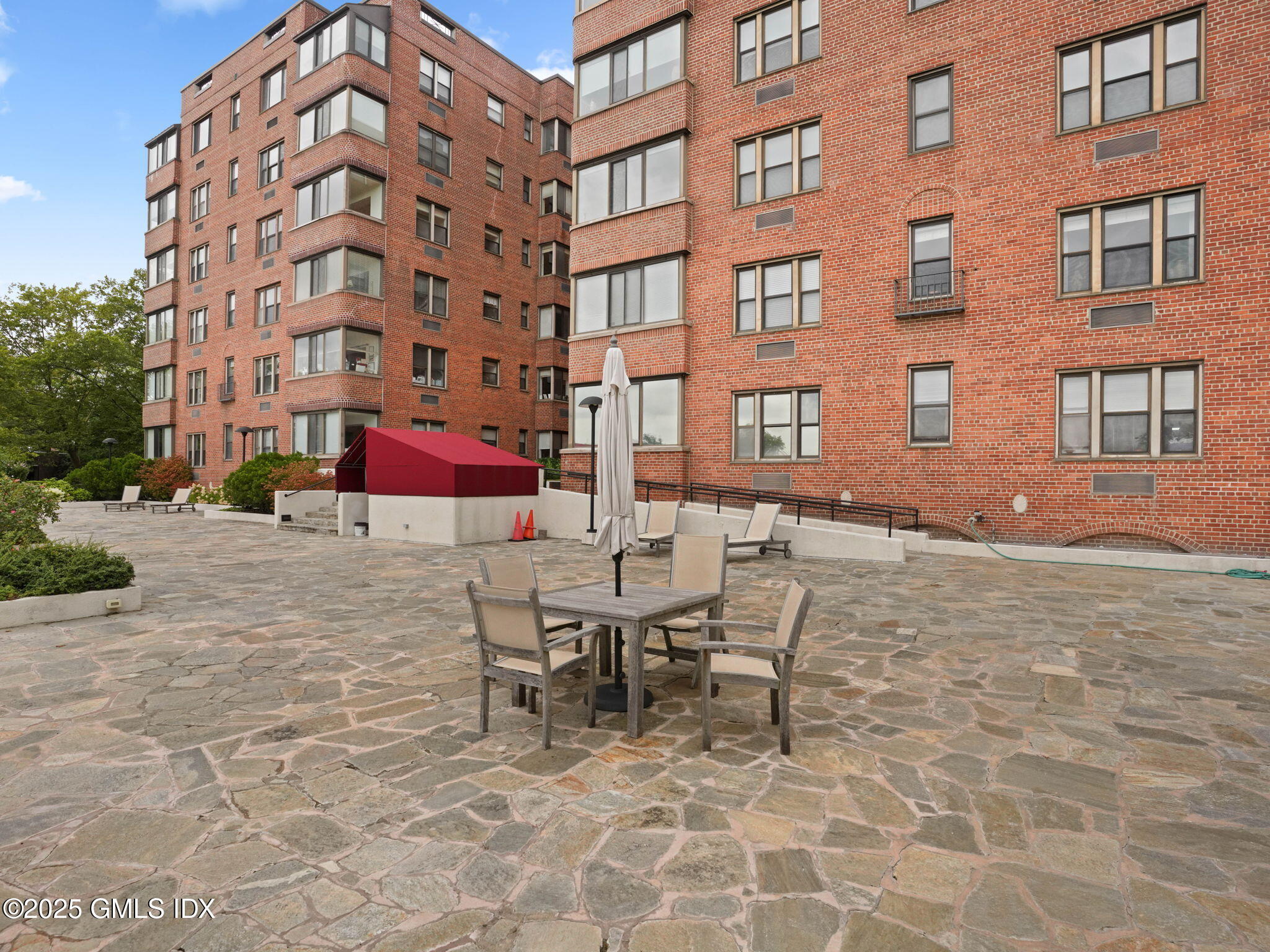 40 West Elm Street, Unit 1M Greenwich, CT 06830 - Photo 15 of 16 a view of a building with dining table and chairs